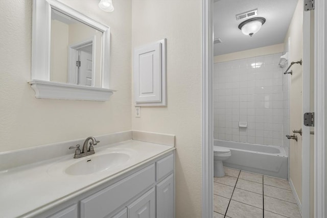 full bath with visible vents, toilet, vanity,  shower combination, and tile patterned flooring