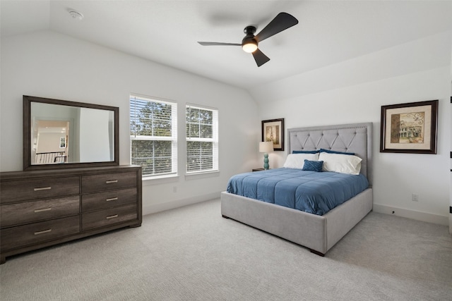 bedroom featuring ceiling fan, light colored carpet, and vaulted ceiling