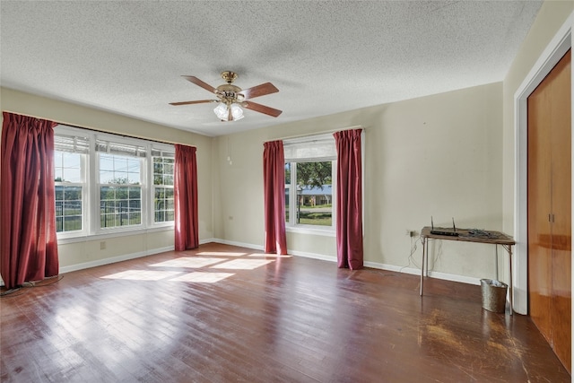 spare room featuring ceiling fan, hardwood / wood-style flooring, and a textured ceiling