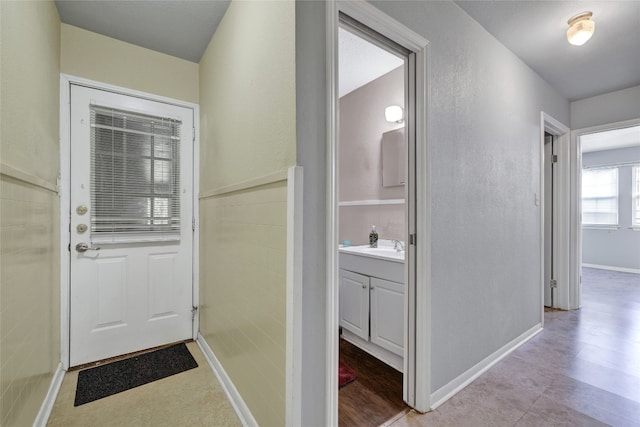 doorway to outside featuring sink