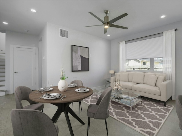 living room with hardwood / wood-style floors and ceiling fan