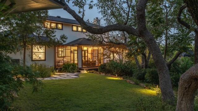 rear view of house with a yard