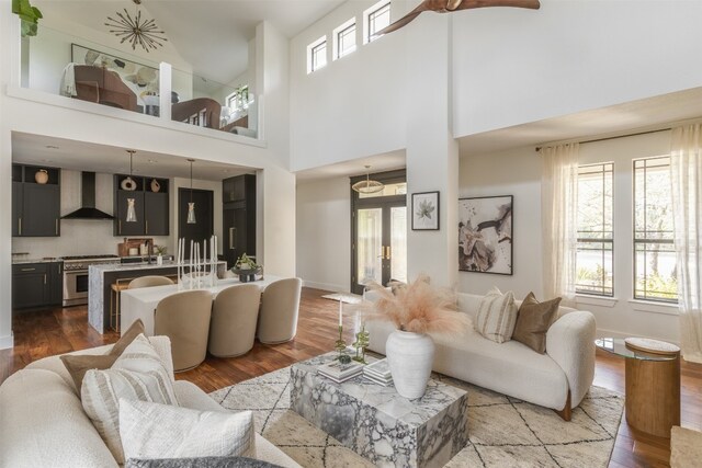 living room featuring plenty of natural light, hardwood / wood-style floors, and a high ceiling