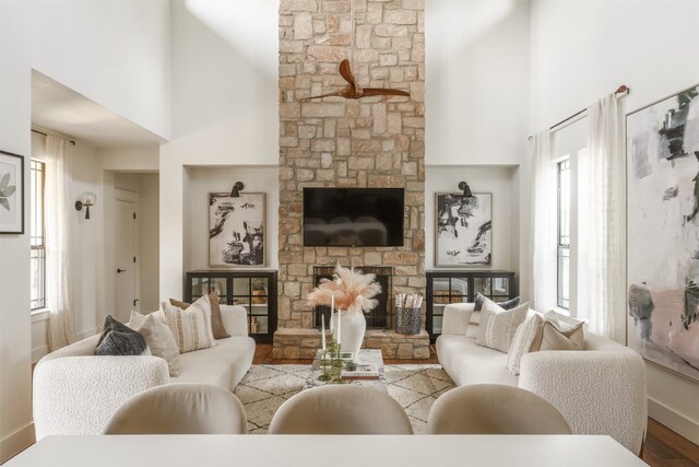 living room with a healthy amount of sunlight, a high ceiling, and light wood-type flooring