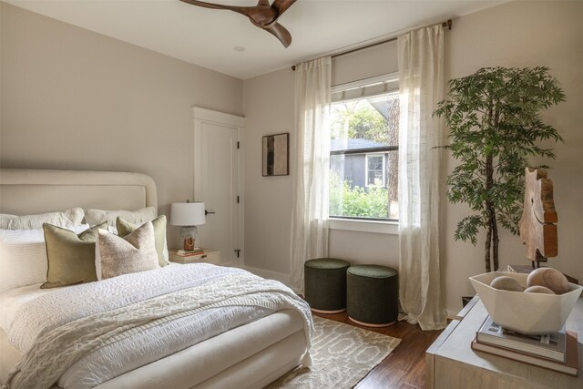 bedroom with dark hardwood / wood-style floors and ceiling fan