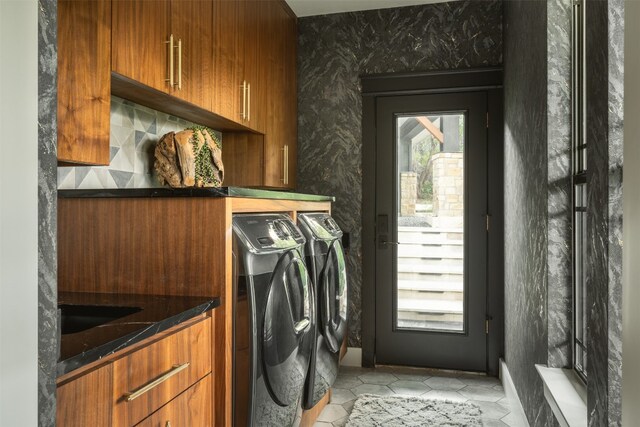 laundry area featuring cabinets and washer and dryer