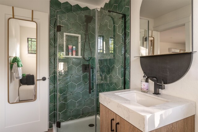 bathroom with vanity and an enclosed shower