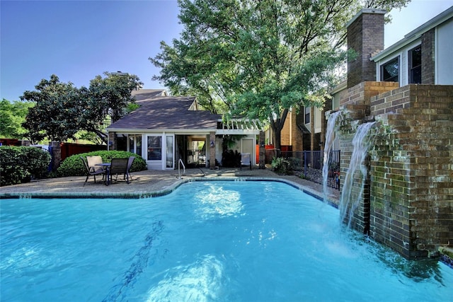 view of pool with a patio area and pool water feature