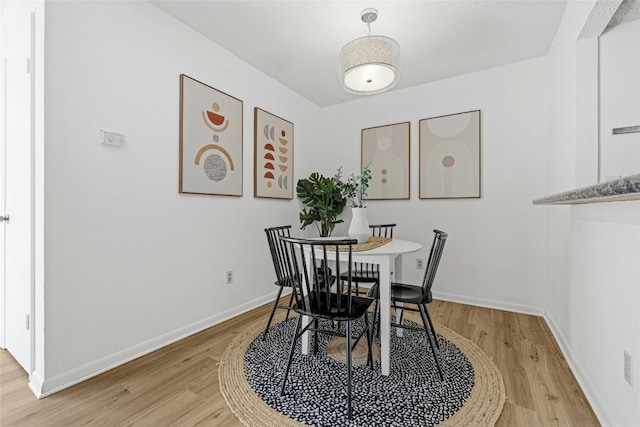 dining space with hardwood / wood-style flooring