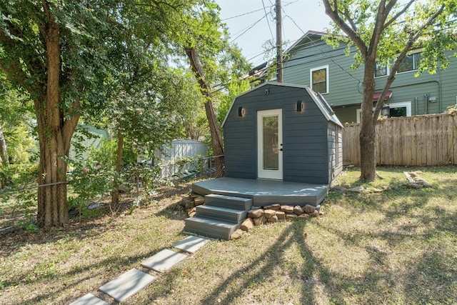 exterior space with a storage shed, a lawn, an outdoor structure, and fence