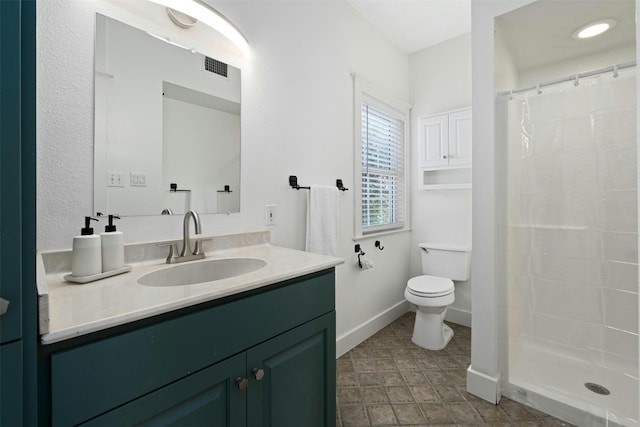 full bath featuring a shower stall, visible vents, baseboards, and vanity