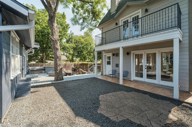 view of yard featuring a patio, french doors, fence, and a jacuzzi