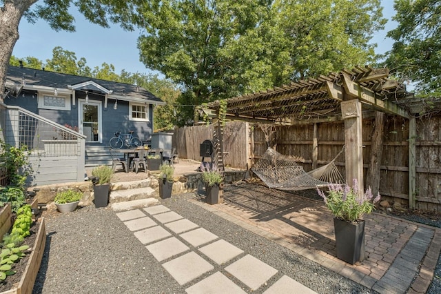 view of patio with fence and a pergola