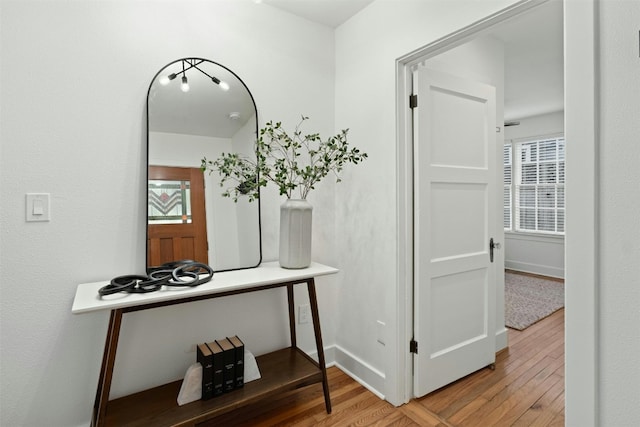 hall with wood finished floors and baseboards