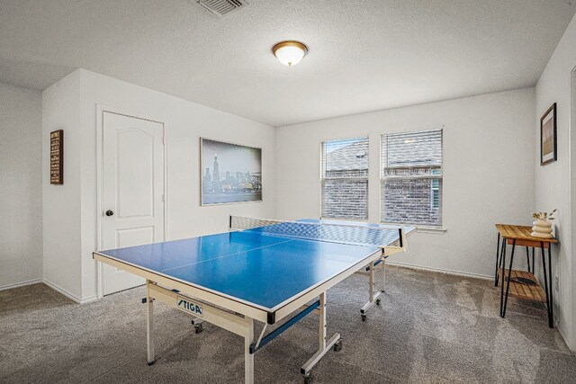 game room featuring a textured ceiling and carpet flooring