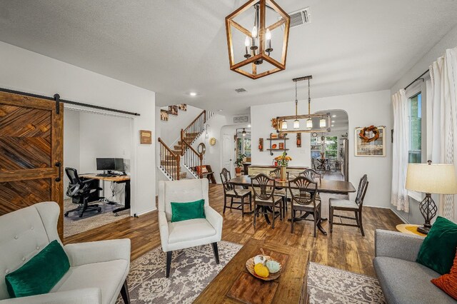 living room featuring wood-type flooring and a barn door