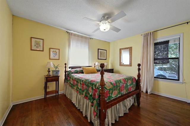 bedroom featuring multiple windows, a textured ceiling, dark hardwood / wood-style floors, and ceiling fan