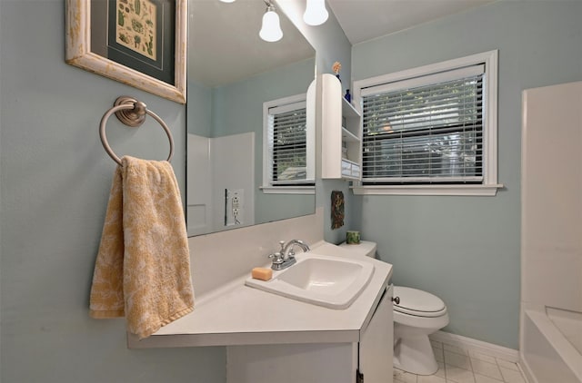 bathroom featuring tile patterned flooring, vanity, a bath, and toilet