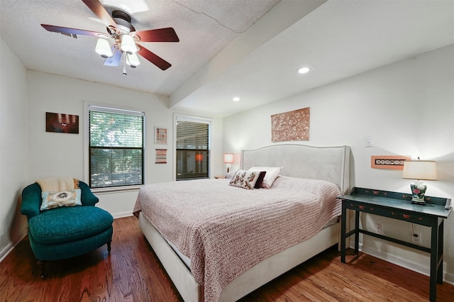 bedroom featuring a textured ceiling, ceiling fan, and dark wood-type flooring