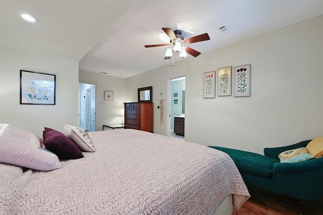 bedroom with wood-type flooring, connected bathroom, and ceiling fan