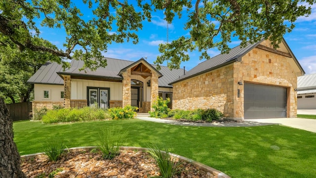 view of front of house with a front yard and a garage