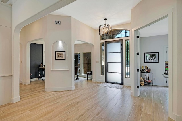 foyer entrance featuring a notable chandelier and light hardwood / wood-style floors