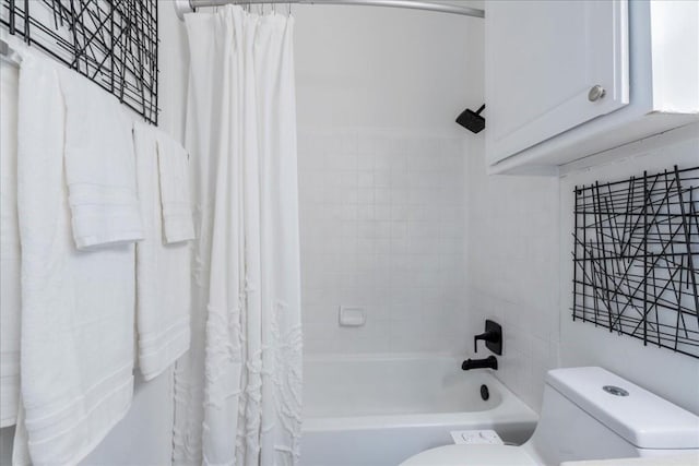 bathroom featuring shower / bath combination with curtain and toilet