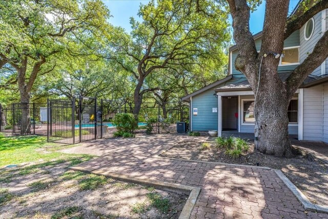 view of yard with a fenced in pool and a patio area