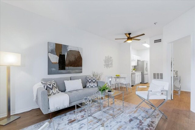 living room with ceiling fan and wood-type flooring