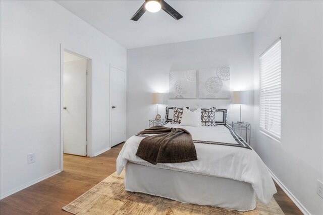 bedroom with light wood-type flooring and ceiling fan