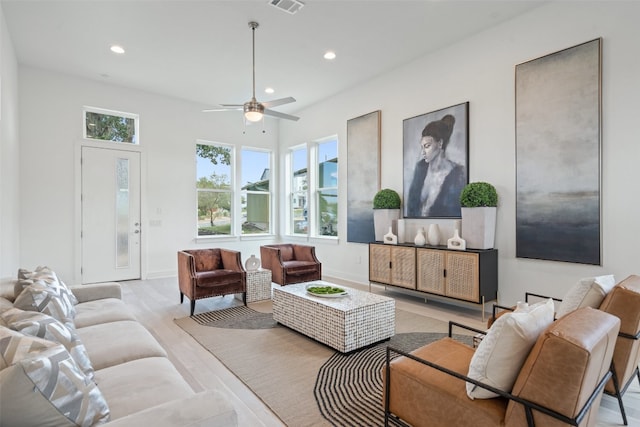 living room with light hardwood / wood-style flooring and ceiling fan