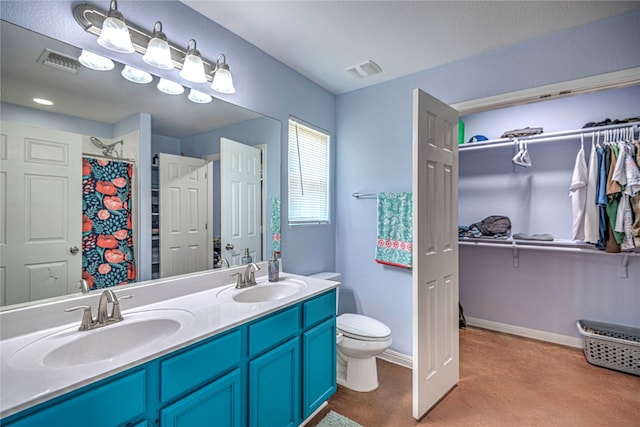 bathroom featuring curtained shower, vanity, and toilet