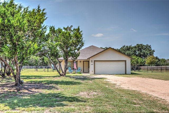 view of front of property featuring a garage and a front lawn