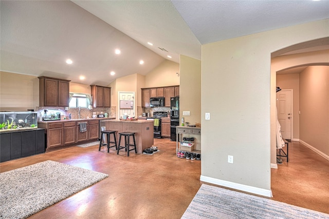 interior space featuring sink, vaulted ceiling, and a textured ceiling