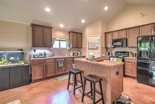 kitchen with black appliances, vaulted ceiling, a center island, and tasteful backsplash