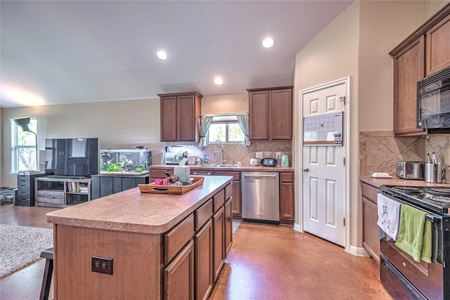 kitchen with a kitchen island, sink, decorative backsplash, and black appliances