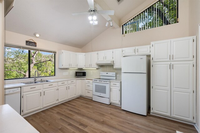 kitchen with white appliances, light countertops, a sink, and under cabinet range hood