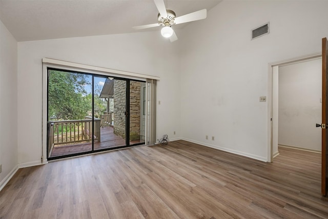 unfurnished room featuring ceiling fan, high vaulted ceiling, and light hardwood / wood-style flooring