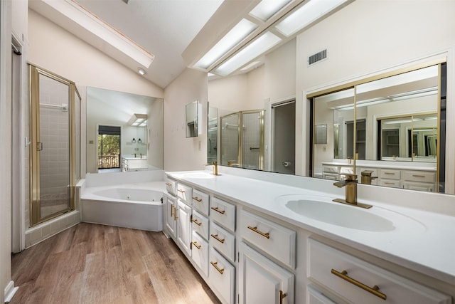 bathroom featuring hardwood / wood-style flooring, shower with separate bathtub, lofted ceiling, and vanity