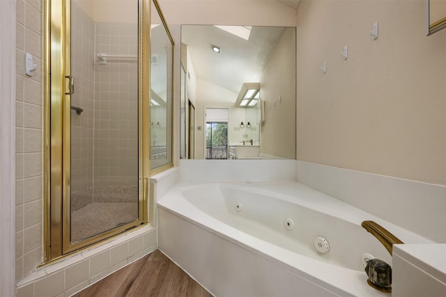 bathroom featuring vaulted ceiling, independent shower and bath, and hardwood / wood-style floors