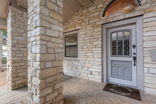 view of exterior entry featuring stone siding