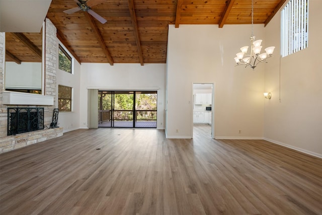 unfurnished living room featuring a fireplace, wood ceiling, wood finished floors, baseboards, and ceiling fan with notable chandelier