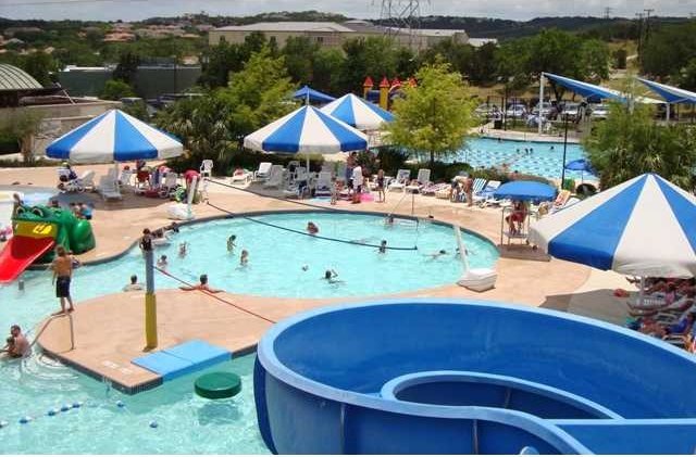 view of pool with a water slide and a patio area