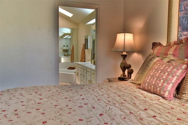 bedroom with ensuite bath and vaulted ceiling with skylight