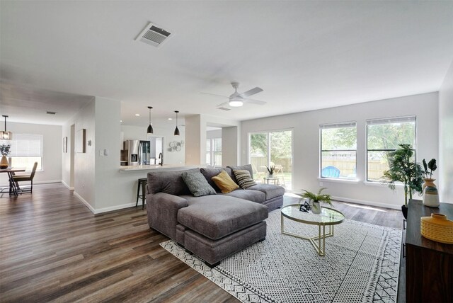 living room with wood-type flooring and ceiling fan