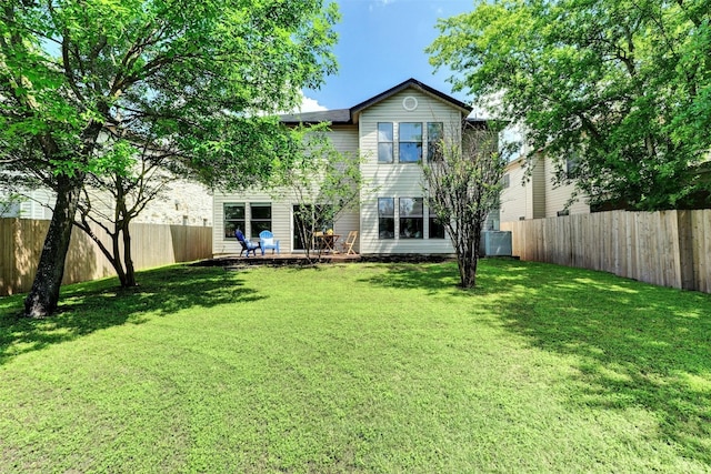 back of property featuring a lawn and central AC unit