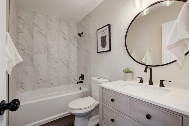 full bathroom featuring tiled shower / bath combo, vanity, toilet, and wood-type flooring