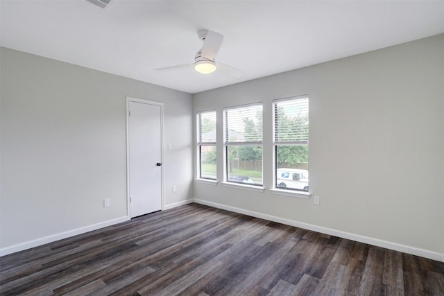 unfurnished room featuring ceiling fan and dark wood-type flooring