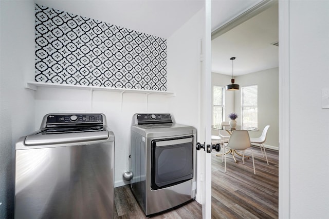 washroom with independent washer and dryer and dark wood-type flooring