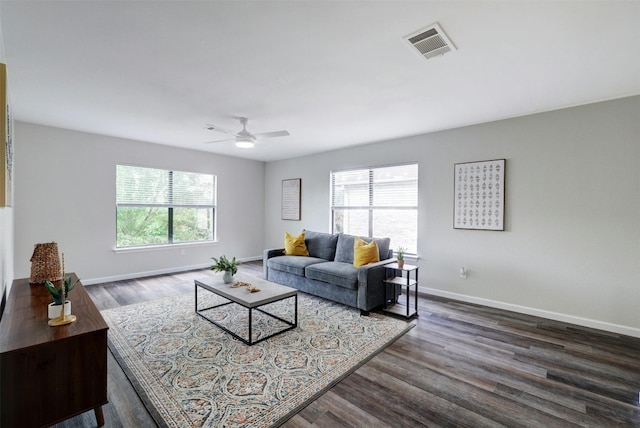 living room featuring ceiling fan, dark hardwood / wood-style flooring, and a healthy amount of sunlight